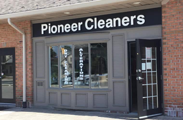 A storefront with a sign for Pioneer Cleaners above the entrance.